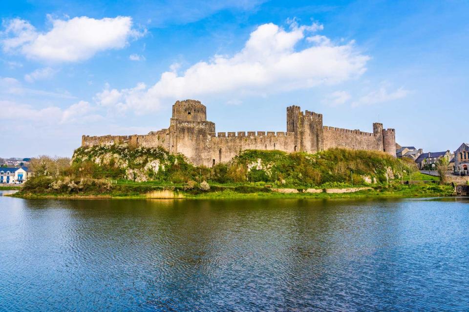 Landscape with the ruins of Pembroke Castle on the shores of river Pembroke, the original family seat of the Earldom of Pembroke