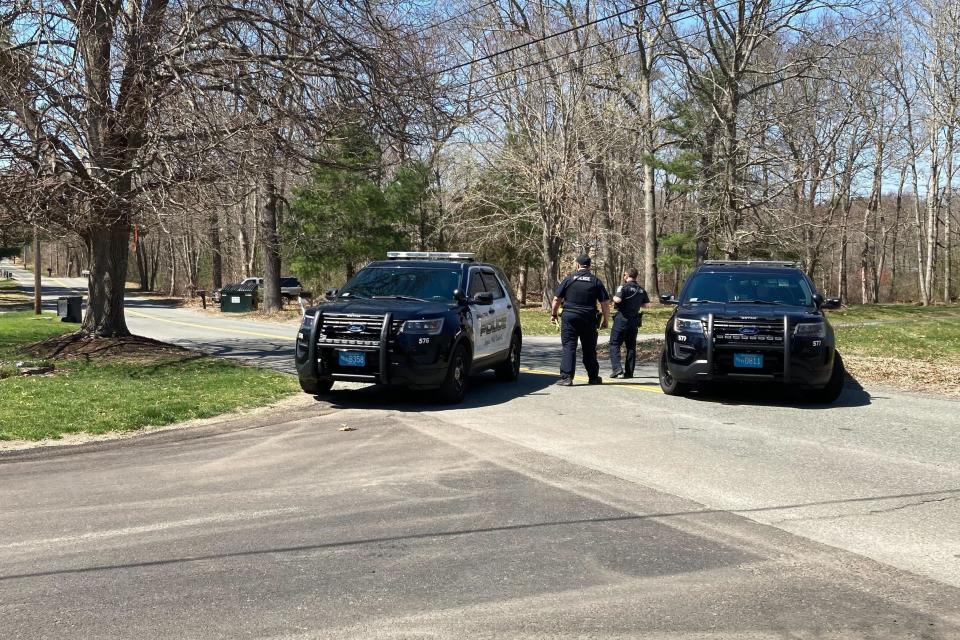 Police block a road in North Dighton, Mass., Thursday, April 13, 2023. The FBI wants to question a 21-year-old member of the Massachusetts Air National Guard in connection with the disclosure of highly classified military documents on the Ukraine war, two people familiar with the investigation said. (AP Photo/Michelle R. Smith)