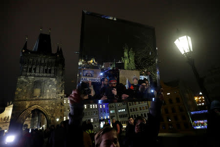 A demonstrator holds a mirror during a protest rally demanding resignation of Czech Prime Minister Andrej Babis in Prague, Czech Republic, November 23, 2018. REUTERS/David W Cerny