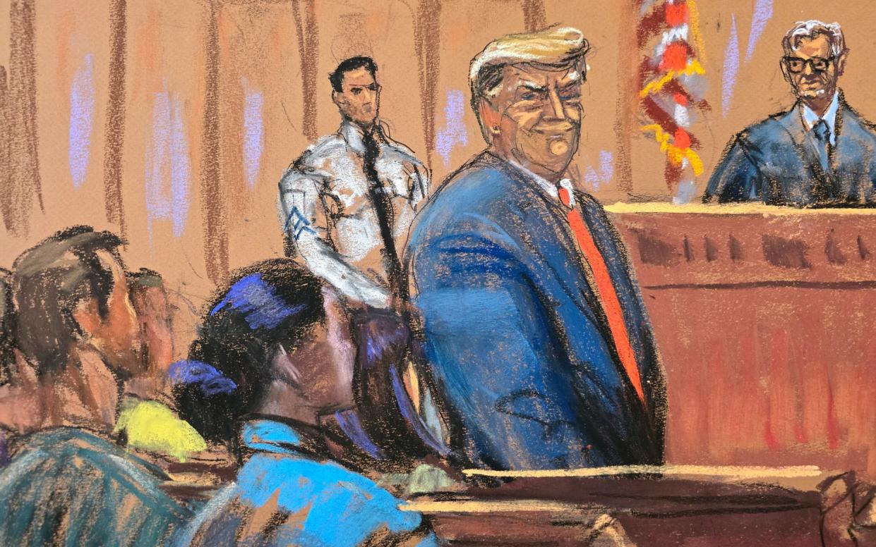 Donald Trump smiles to the jury pool as he is introduced to them