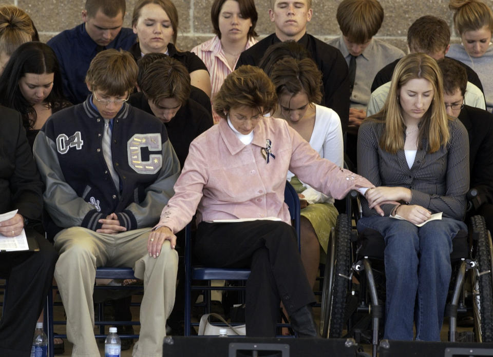 Anne Marie Hochhalter (right) prays during an event to remember&nbsp;those lost during the&nbsp;Columbine&nbsp;attack. She says she became disillusioned with her lawmakers over time. (Photo: Hyoung Chang via Getty Images)