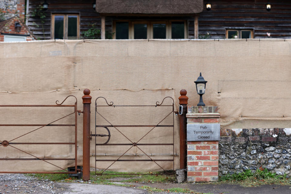 A sign said the pub was temporarily closed. The Crown Inn pub, owned by Russell Brand's company, has been fenced off in the wake of sexual assault and rape allegations. (Reuters/Hollie Adams)