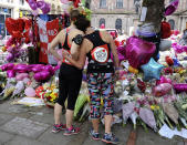 <p>Marathon runners pay respects at flower tributes in St Ann’s square, before the Great Manchester Run in Manchester, England, Sunday, May 28, 2017. More than 20 people were killed in an explosion following a Ariana Grande concert at the Manchester Arena late Monday evening. (Photo: Rui Vieira/AP) </p>