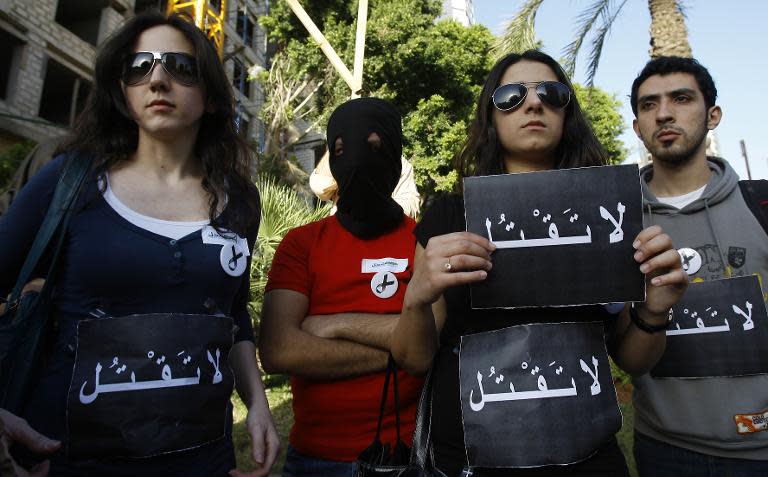 Lebanese human rights activists hold signs saying "Do not kill" outside the Saudi embassy in Beirut