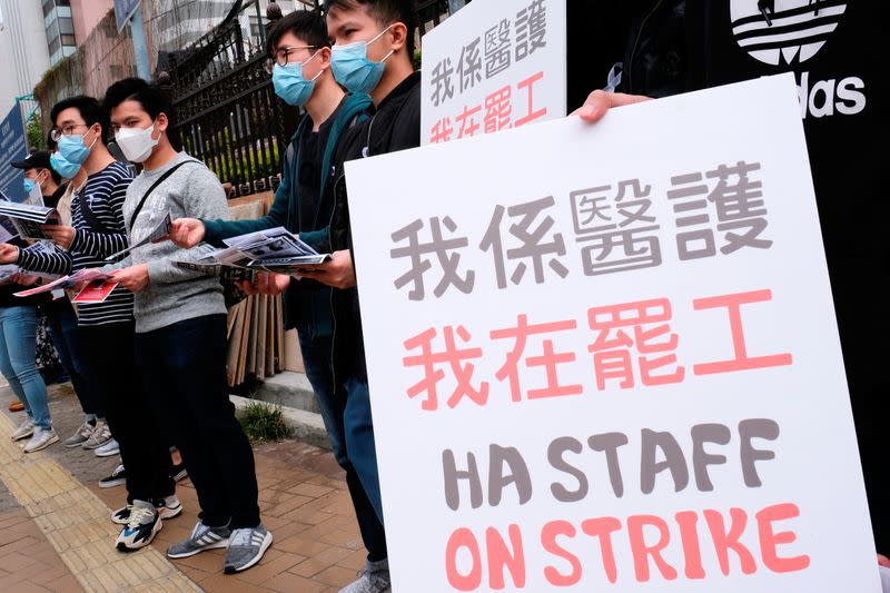 Medical workers hold a strike near Queen Elizabeth Hospital as they demand Hong Kong close its border with China to reduce the coronavirus spreading, in Hong Kong