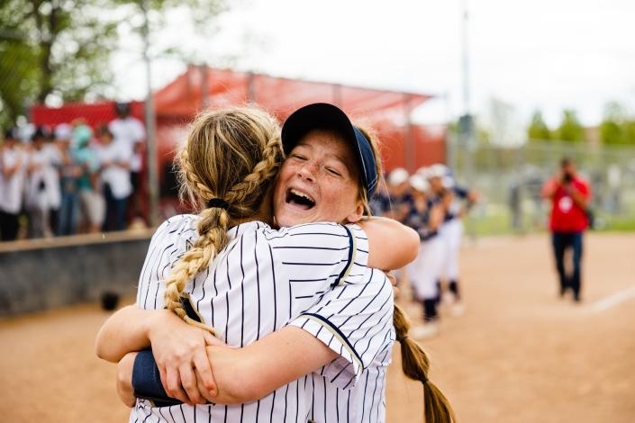 Enterprise’s Mckinley Hunt (19), right, hugs a teammate after winning the 2A girls softball finals at Spanish Fork Sports Park in Spanish Fork on May 13, 2023. | Ryan Sun, Deseret News