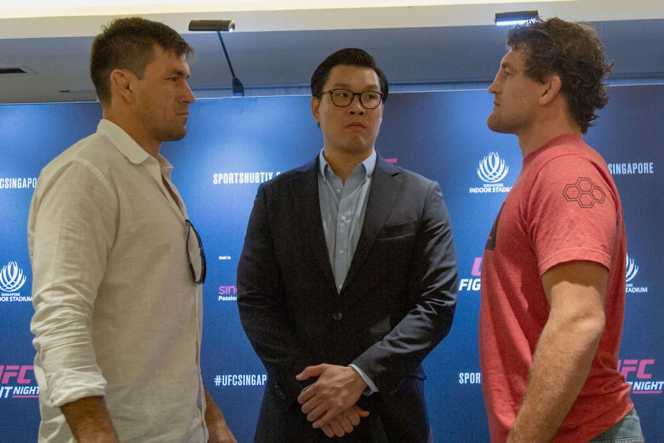 MMA fighters Demian Maia (left) and Ben Askren (right) face off in front of UFC senior vice-president (Asia Pacific) Kevin Chang during the media conference promoting the UFC Fight Night Singapore on 26 October. (PHOTO: Dhany Osman/Yahoo News Singapore)