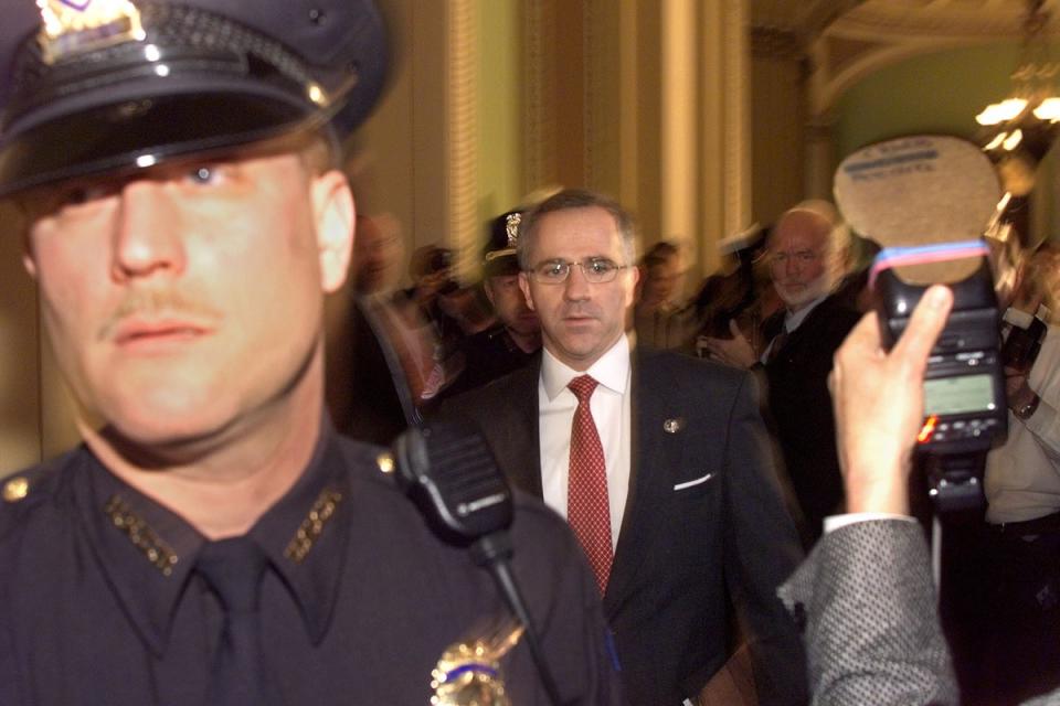 Steve Buyer (R-IN) walks in the halls of the US Senate as Capitol Hill police hold back the media in the halls of the US Senate shortly before the start of the 14 January impeachment trial of US President Bill Clinton (AFP via Getty Images)