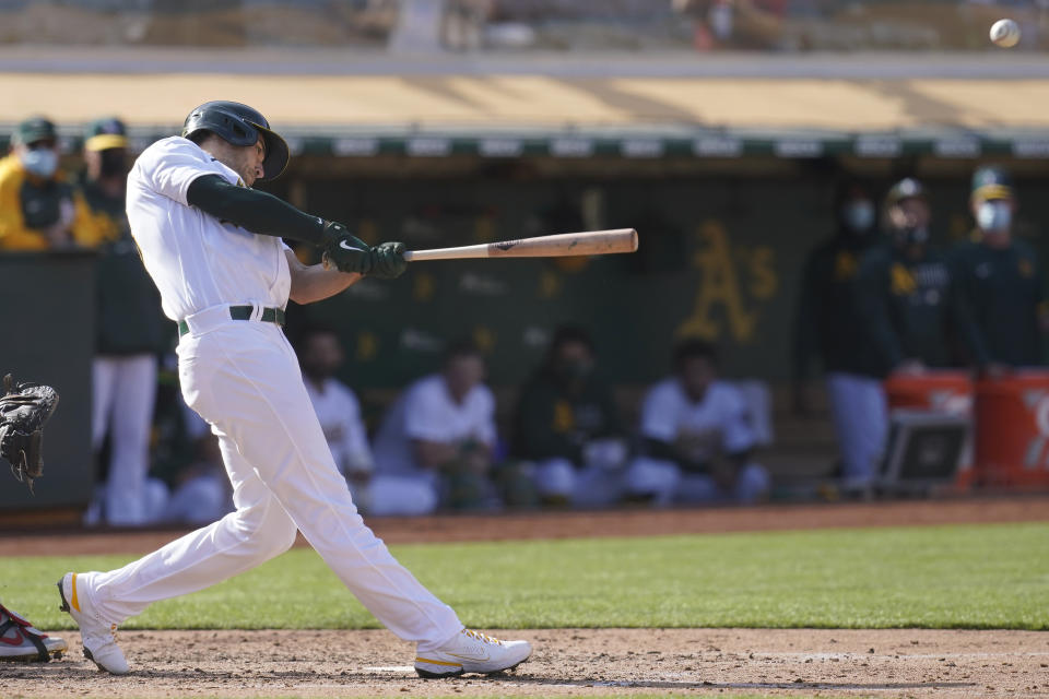 Oakland Athletics' Matt Olson hits a grand slam home run against the Minnesota Twins during the fourth inning of the first baseball game of a doubleheader in Oakland, Calif., Tuesday, April 20, 2021. (AP Photo/Jeff Chiu)