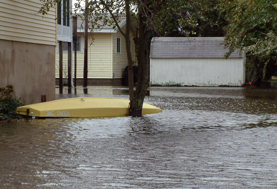 A backyard is inundated with floodwaters in the aftermath of Sandy, Tuesday, Oct. 30, 2012, in Lewes, Del. Sandy, the storm that made landfall Monday, caused multiple fatalities, halted mass transit and cut power to more than 6 million homes and businesses. (AP Photo/Randall Chase)