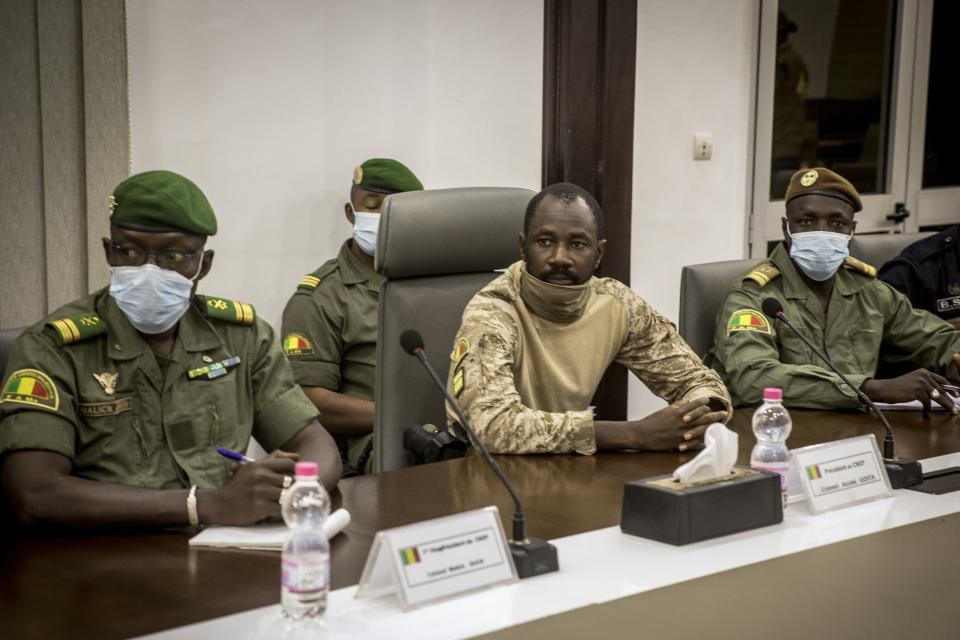 Col. Assimi Goita, center, who has declared himself the leader of the National Committee for the Salvation of the People, is accompanied by group member Malick Diaw, left, as they meet with a high-level delegation from the West African regional bloc known as ECOWAS, at the Ministry of Defense in Bamako, Mali, Saturday, Aug. 22, 2020. Top West African officials are arriving in Mali's capital following a coup in the nation this week to meet with the junta leaders and the deposed president in efforts to negotiate a return to civilian rule. (AP Photo)
