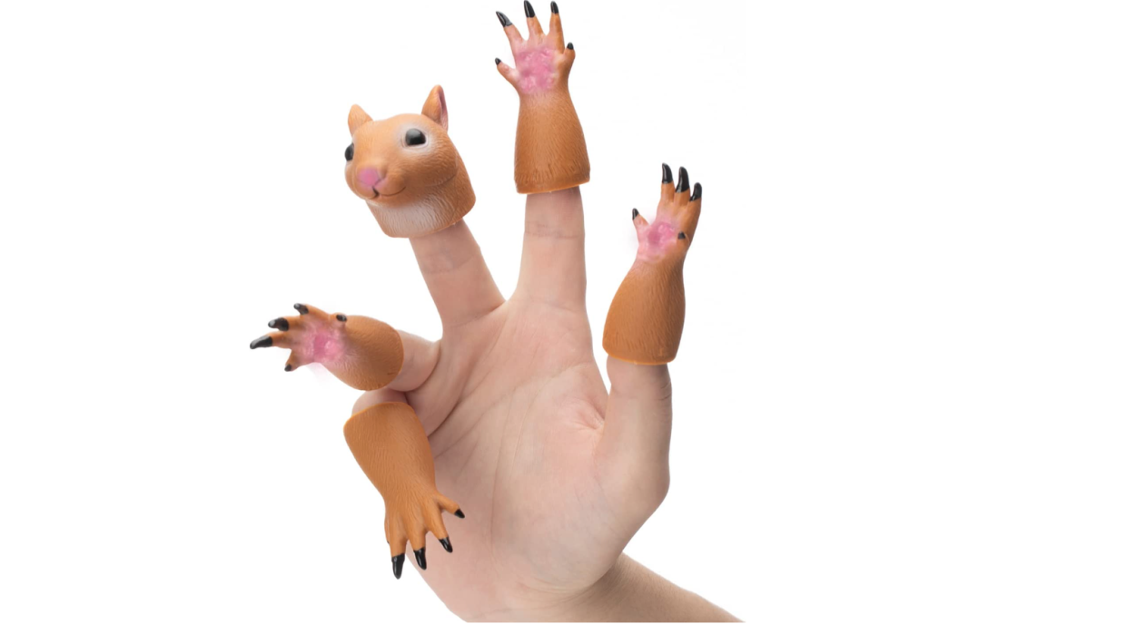 Tiny squirrel toy parts worn on a human hand