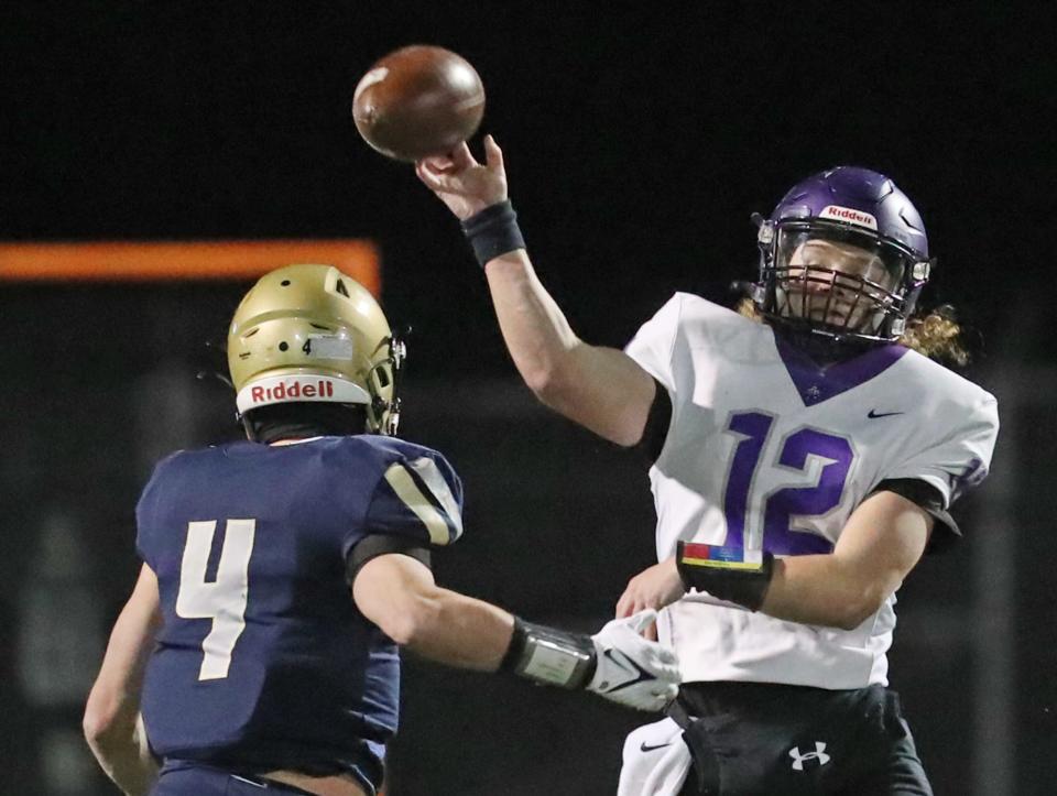 Archbishop Hoban outside linebacker Tanner Mintz pressures Barberton quarterback Dominic Wilson during a regional quarterfinal Nov. 3 in Akron.