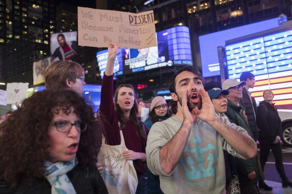 Protesters march through Times Square during a demonstration in support of special counsel Robert Mueller, Thursday, Nov. 8, 2018, in New York. A protest in New York City has drawn several hundred people calling for the protection of Mueller's investigation into potential coordination between Russia and President Donald Trump's campaign. (AP Photo/Mary Altaffer)