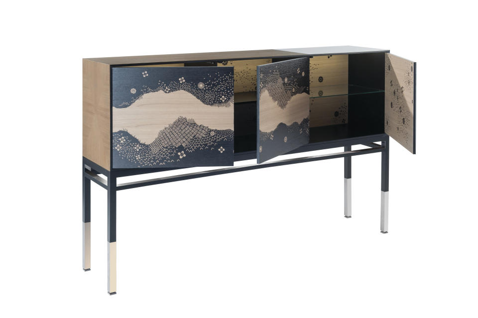 This undated photo provided by Roche Bobois shows one of pieces from Roche Bobois' Bois Paradis collection from Maison Lacroix. The collection features wood cabinets and screens, and upholstered seating, printed with a woodland scene. On the casegoods and tables the pattern is in silhouette, giving them a wonderful air of mystery. (Roche Bobois via AP)