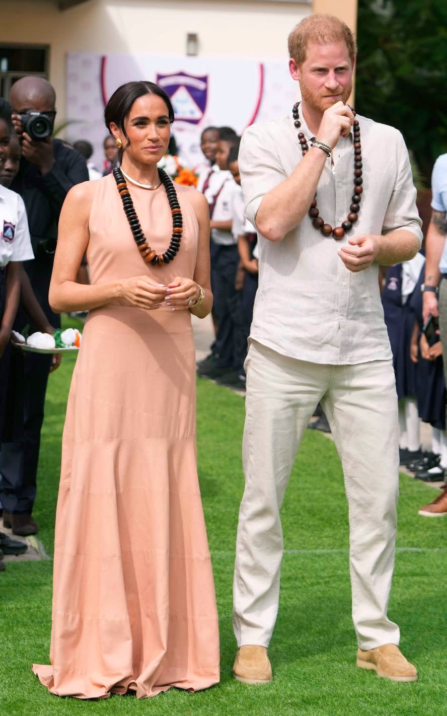 The Duchess's first outfit was a 'Windsor' style blush silk maxi dress by Heidi Merrick