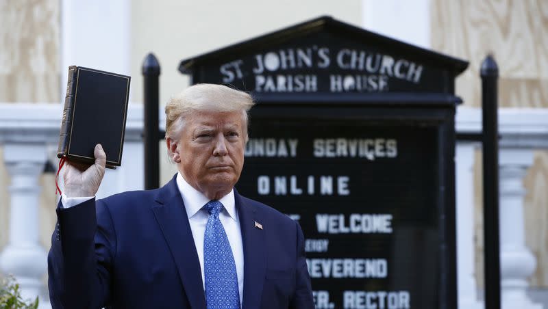 President Donald Trump holds a Bible as he visits outside St. John’s Church across Lafayette Park from the White House Monday, June 1, 2020, in Washington. Part of the church was set on fire during protests.