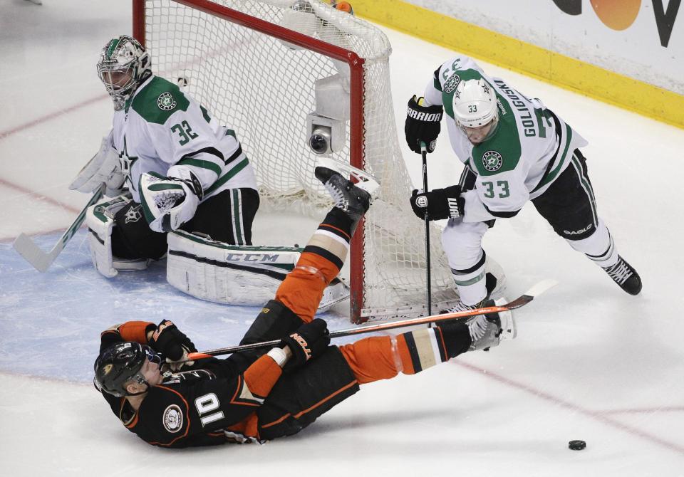 Anaheim Ducks' Corey Perry (10) falls to the ice after he was pushed by Dallas Stars' Alex Goligoski (33) as Stars goalie Kari Lehtonen, of Finland, watches during the first period in Game 2 of the first-round NHL hockey Stanley Cup playoff series, Friday, April 18, 2014, in Anaheim, Calif. (AP Photo/Jae C. Hong)