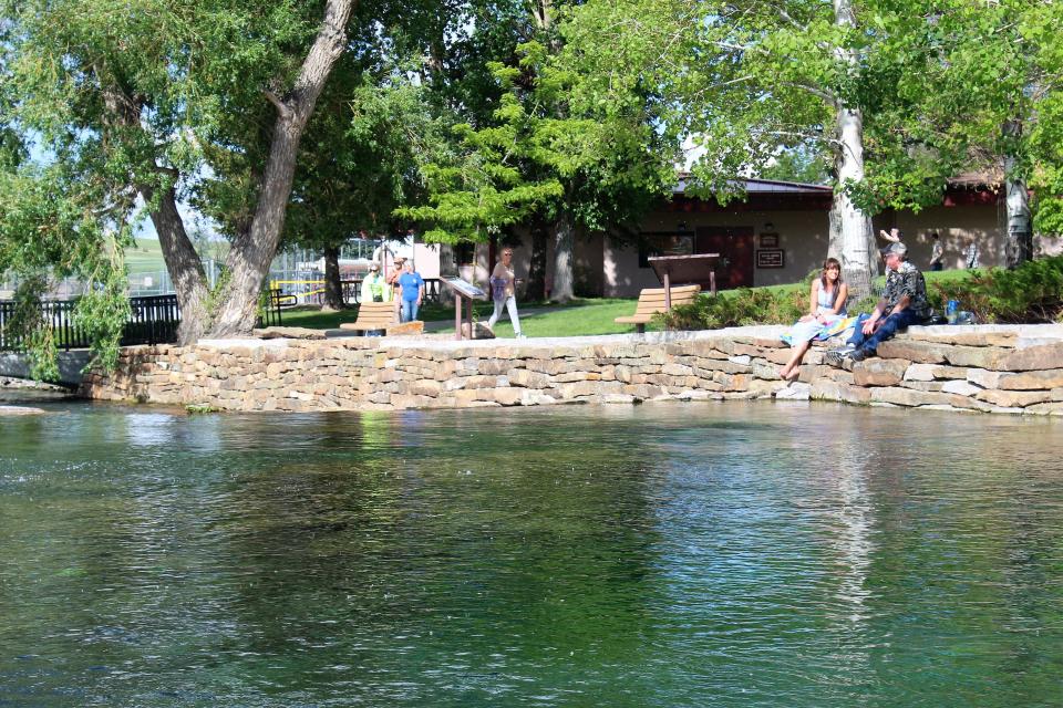 Visitors to Giant Springs State Park enjoy the spring's rebuilt retaining wall, built using the same tools and practices original stonemasons used when the wall was first built in 1915.