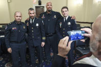 U.S. Capitol Police Sgt. Aquilino Gonell, from left, Washington Metropolitan Police Department officer Michael Fanone, U.S. Capitol Police Sgt. Harry Dunn and Washington Metropolitan Police Department officer Daniel Hodges, pose for a photo after testifying before the House select committee hearing on the Jan. 6 attack on Capitol Hill in Washington, Tuesday, July 27, 2021. (Chip Somodevilla/Pool via AP)