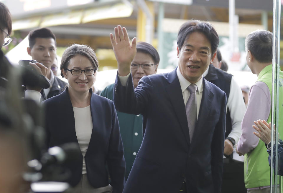 Taiwan Vice President William Lai, right, the candidate for presidential election of the ruling Democratic Progressive Party (DPP), reacts to media members as he was with his vice president candidate Hsiao Bi-kim, left, former Taiwanese representative to the United States, at a news conference in Taipei, Taiwan, Monday, Nov. 20, 2023. (AP Photo/Chiang Ying-ying)