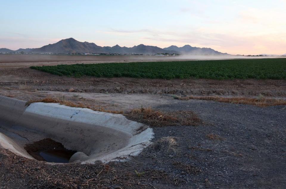 A view of soil and dust kicked up from a vehicle along a farm road in the Phoenix suburb of Queen Creek on June 9, 2023.