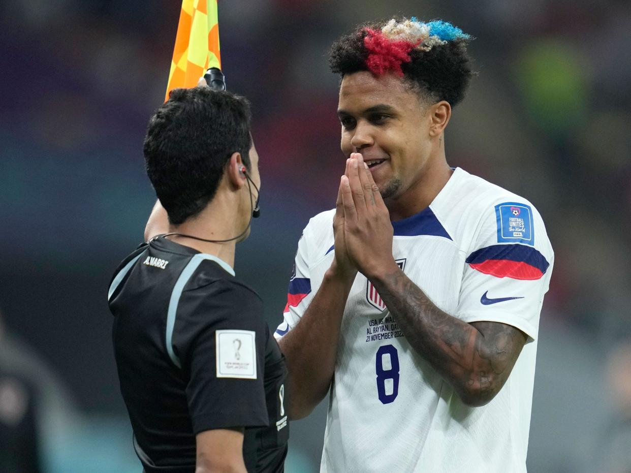 Weston McKennie pleads with a side judge during a match against Wales at Qatar 2022.