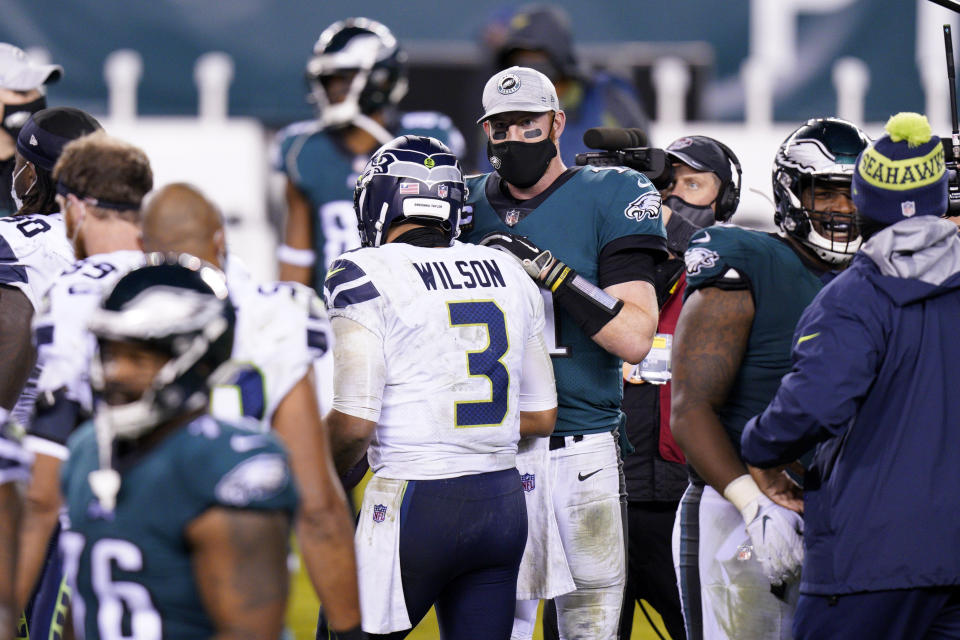 Philadelphia Eagles' Carson Wentz, right, and Seattle Seahawks' Russell Wilson meet after an NFL football game, Monday, Nov. 30, 2020, in Philadelphia. (AP Photo/Chris Szagola)