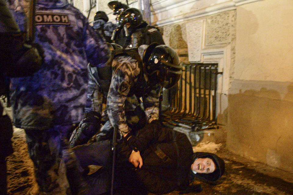 Police officers detain a Navalny supporter at the Red Square in Moscow, Russia, Tuesday, Feb. 2, 2021. A Moscow court has ordered Russian opposition leader Alexei Navalny to prison for more than 2 1/2 years on charges that he violated the terms of his probation while he was recuperating in Germany from nerve-agent poisoning. Navalny, who is the most prominent critic of President Vladimir Putin, had earlier denounced the proceedings as a vain attempt by the Kremlin to scare millions of Russians into submission. (AP Photo/Denis Kaminev)