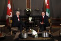 Jordan's King Abdullah (R) meets Canada's Prime Minister Stephen Harper at the Royal Palace in Amman January 23, 2014. REUTERS/Muhammad Hamed (JORDAN - Tags: POLITICS ROYALS)