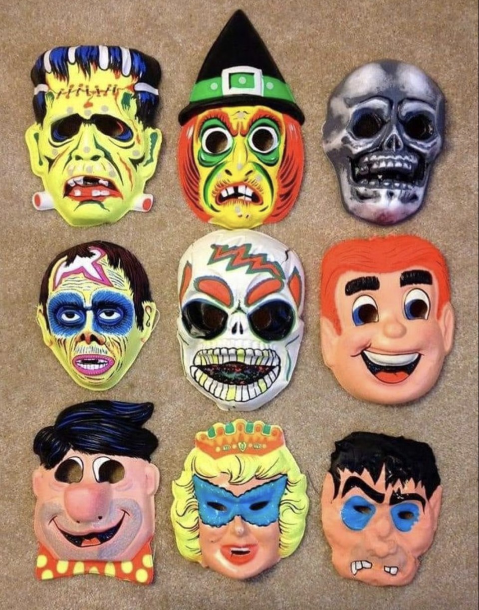 Nine Halloween masks including Frankenstein's monster, a witch, a skull, a zombie, a sugar skull, a cartoon man, a cartoon woman, a superhero, and a wrestler