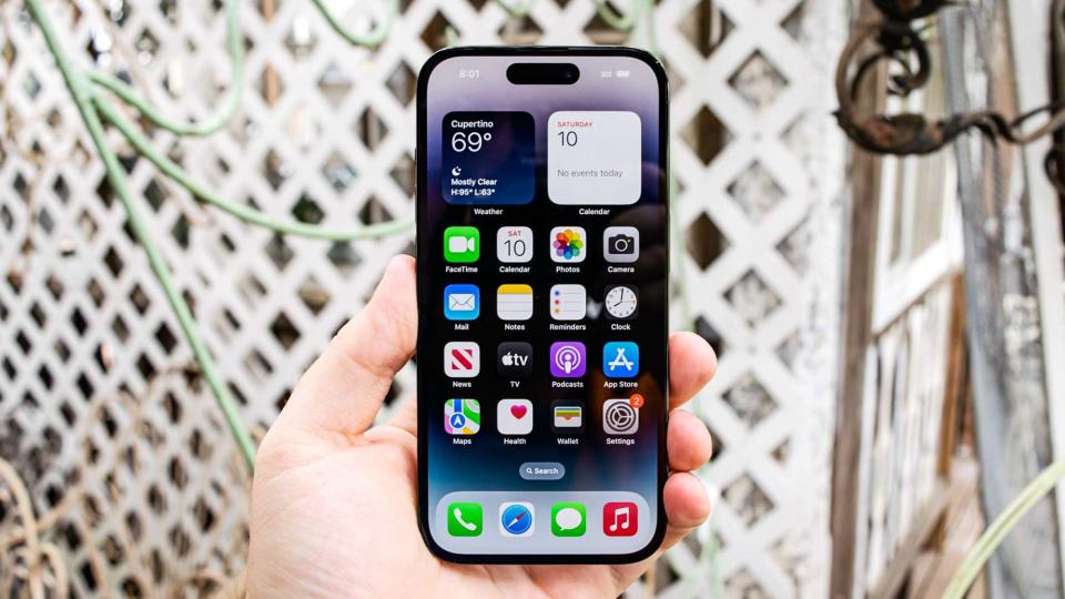 iPhone 14 Pro shown from front displaying iOS16 home screen