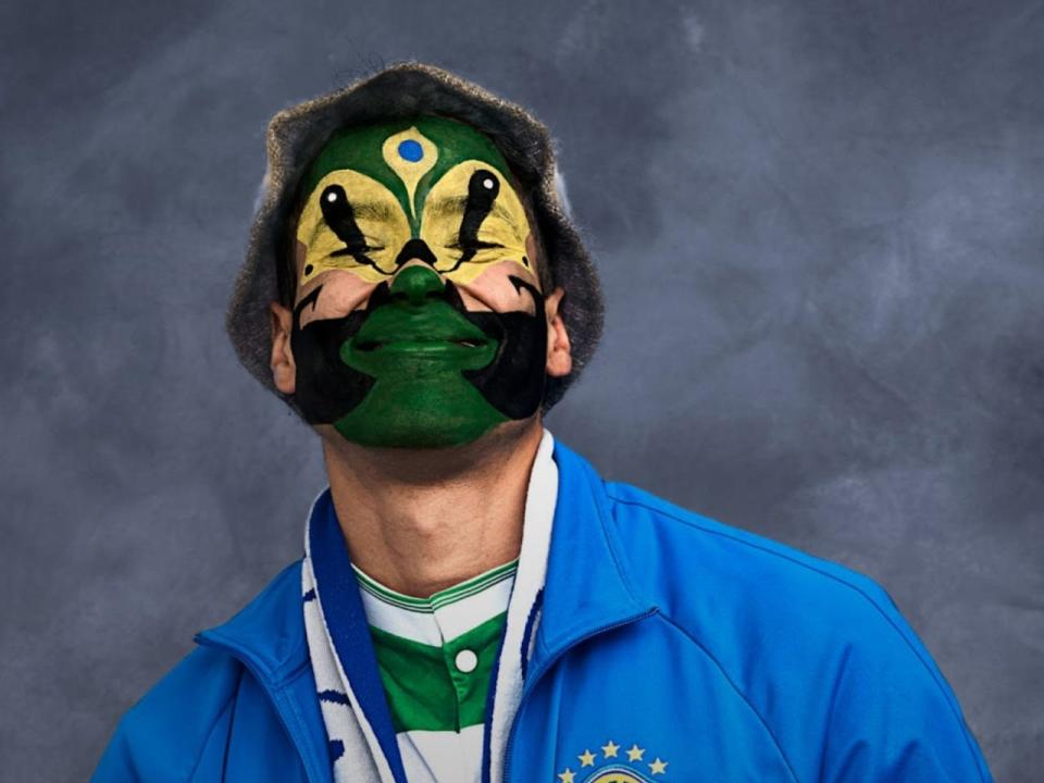 A person with green and yellow face paint