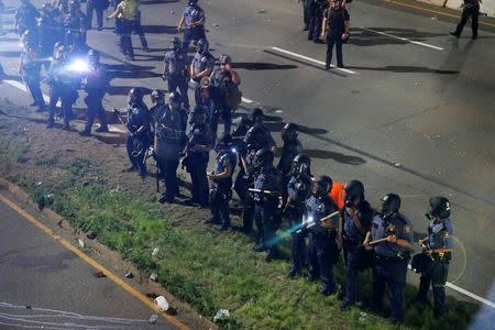 Police are seen as people gather on Interstate 94 to protest the fatal shooting of Philando Castile by Minneapolis area police during a traffic stop, in St. Paul, Minnesota, U.S., July 10, 2016. REUTERS/Adam Bettcher