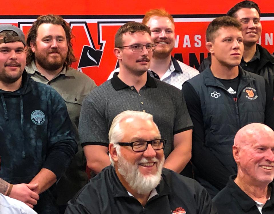 Washington head coach Darrell Crouch (front, center) with 2013 team players Brogan Brownfield (back left) and Casey Danley (back center) at an induction of the 2013 football team into the Washington High School Hall of Fame in mid-October of 2023.