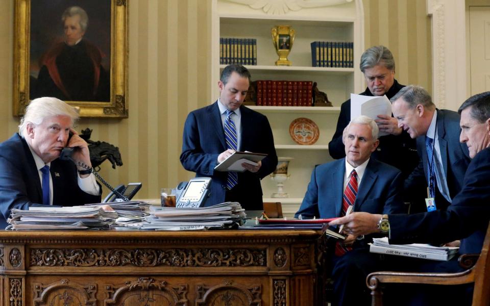 Reince Priebus (centre) in the Oval Office, with the president and other key officials - Credit: Reuters