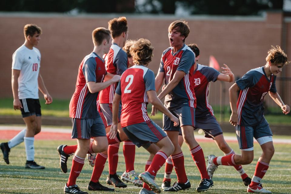 Dover celebrates their first goal against New Philadelphia in an August 2021 game at Crater Stadium.