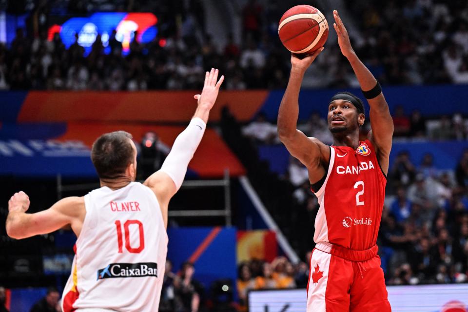 Canada’s Shai Gilgeous-Alexander (R) shoots as Victor Claver look (L) tries to block on during the FIBA Basketball World Cup match between Spain and Canada at Indonesia Arena in Jakarta on September 3, 2023. (Photo by ADEK BERRY / AFP) (Photo by ADEK BERRY/AFP via Getty Images)