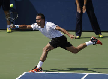 Victor Estrella Burgos, of Dominican Republic, returns a shot against Igor Sijsling, of the Netherlands, during the first round of the 2014 U.S. Open tennis tournament, Tuesday, Aug. 26, 2014, in New York. (AP Photo/Darron Cummings)