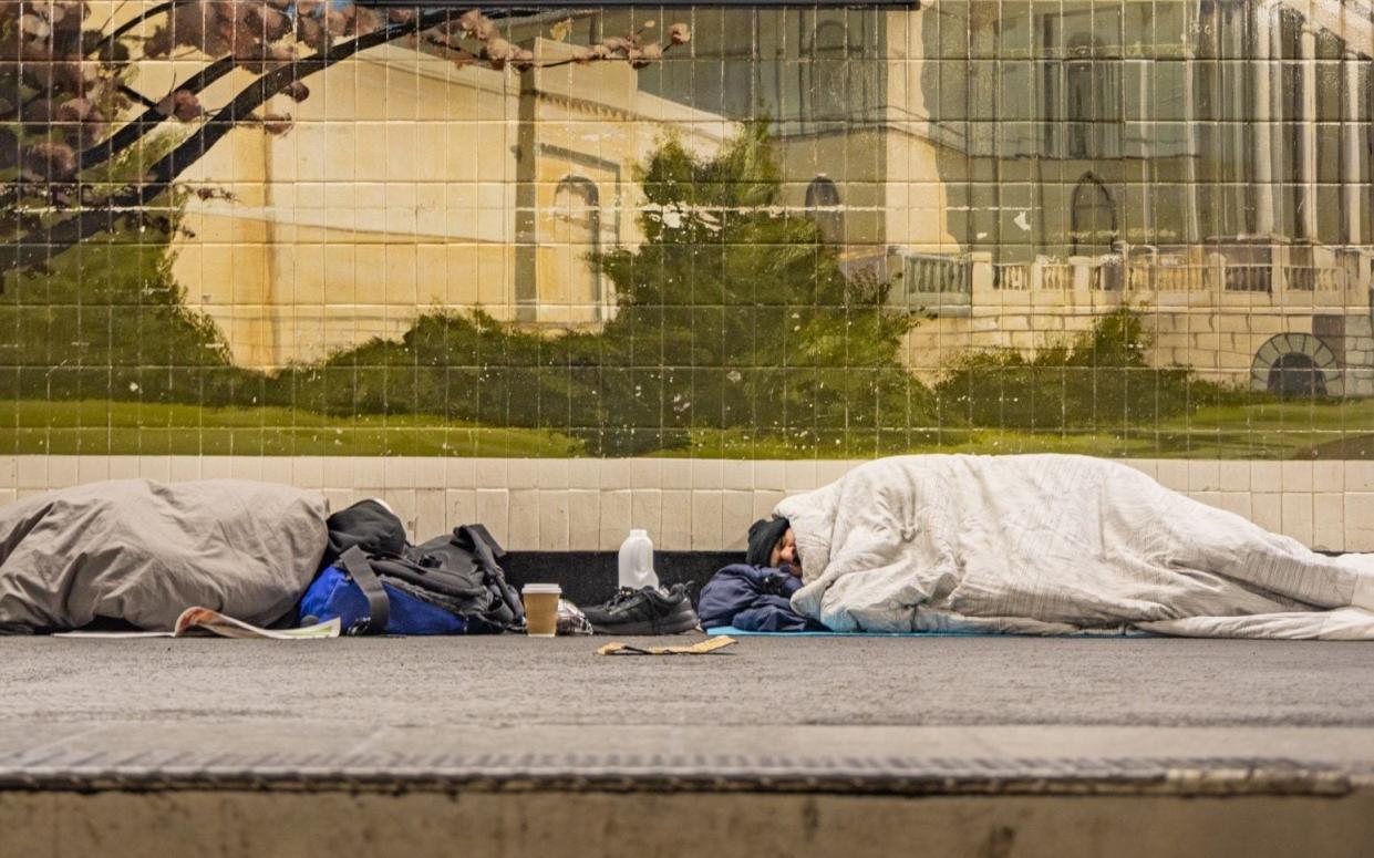 Homeless men sleeping at a platform at the Pimlico Tube station