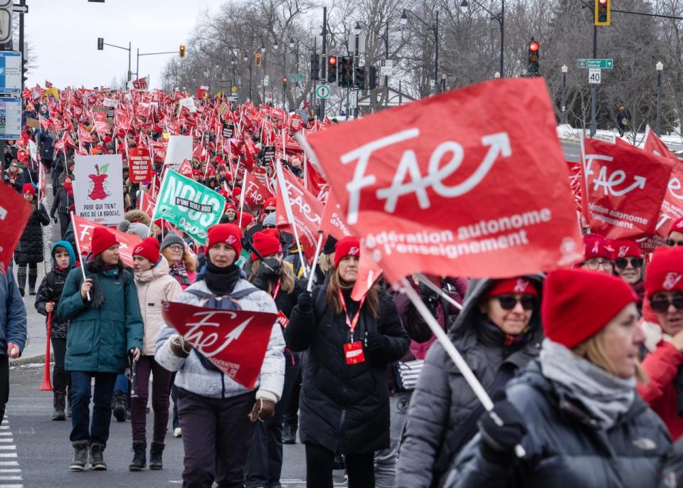 Striking teachers with the FAE union march through the streets to press their contract demands Tuesday, December 12, 2023  in Montreal.THE CANADIAN PRESS/Ryan Remiorz