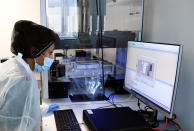 A health worker checks a computer screen at the COVID-19 test department of the Broussais Hospital in Paris, Monday May 11, 2020. French President Emmanuel Macron has repeatedly pledged the country would be able to test up to 700,000 people per week as key to the re-opening process, but so far the number of people tested is much lower and the effective capacities in the country remain vague. (Alain Jocard, Pool via AP)