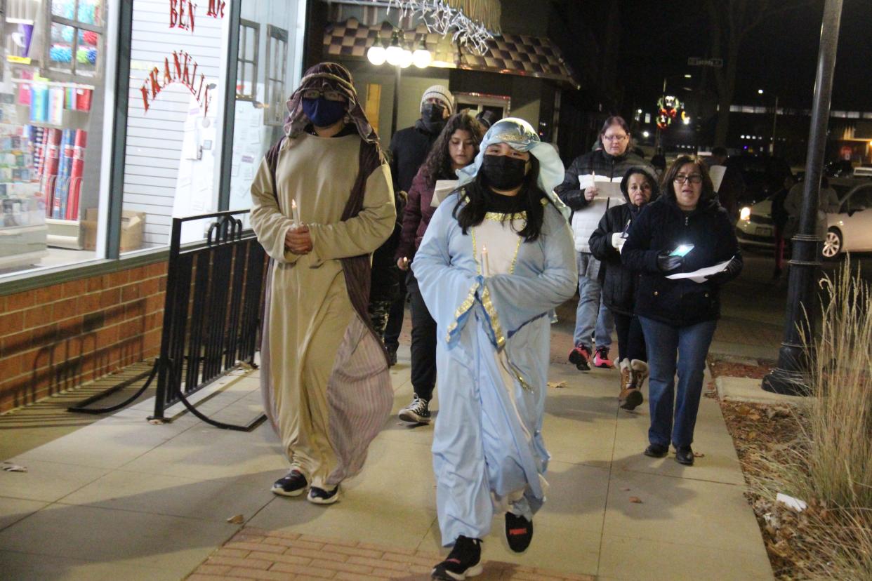 Siblings Steven and Stephanie Mena, dressed as Joseph and Mary, lead the Las Posadas procession on Thursday, Dec. 16.