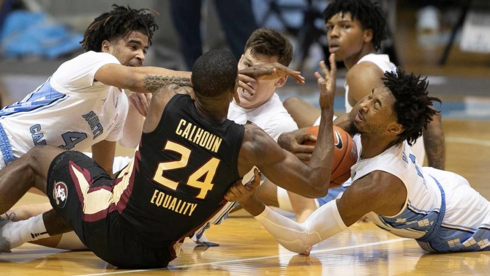 North Carolina’s Leaky Black (1) battles for a loose ball with Florida State’s Sardaar Calhoun (24) during the first half on Saturday, February 27, 2021 in Chapel Hill, N.C.