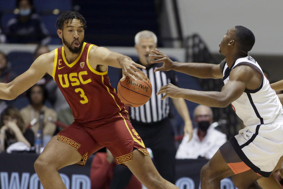 Southern California forward Isaiah Mobley, left, steals a pass by San Diego State guard Lamont Butler during the first half of an NCAA college basketball game at the Wooden Legacy tournament in Anaheim, Calif., Friday, Nov. 26, 2021. (AP Photo/Alex Gallardo)