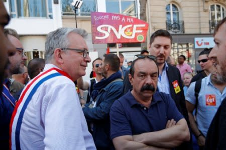 French CGT labour union leader Philippe Martinez (C) and National Secretary of the French Communist party (PC), Pierre Laurent (L) attend a demonstration against the French government's reform plans in Paris as part of a national day of protest, France, April 19, 2018.  REUTERS/Philippe Wojazer