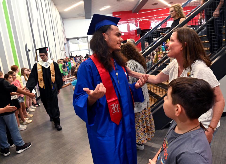 Cooper High School student Tyler Lee greets his fifth grade teacher, Jennifer McLean, during the Senior Walk at Austin Elementary School Tuesday.