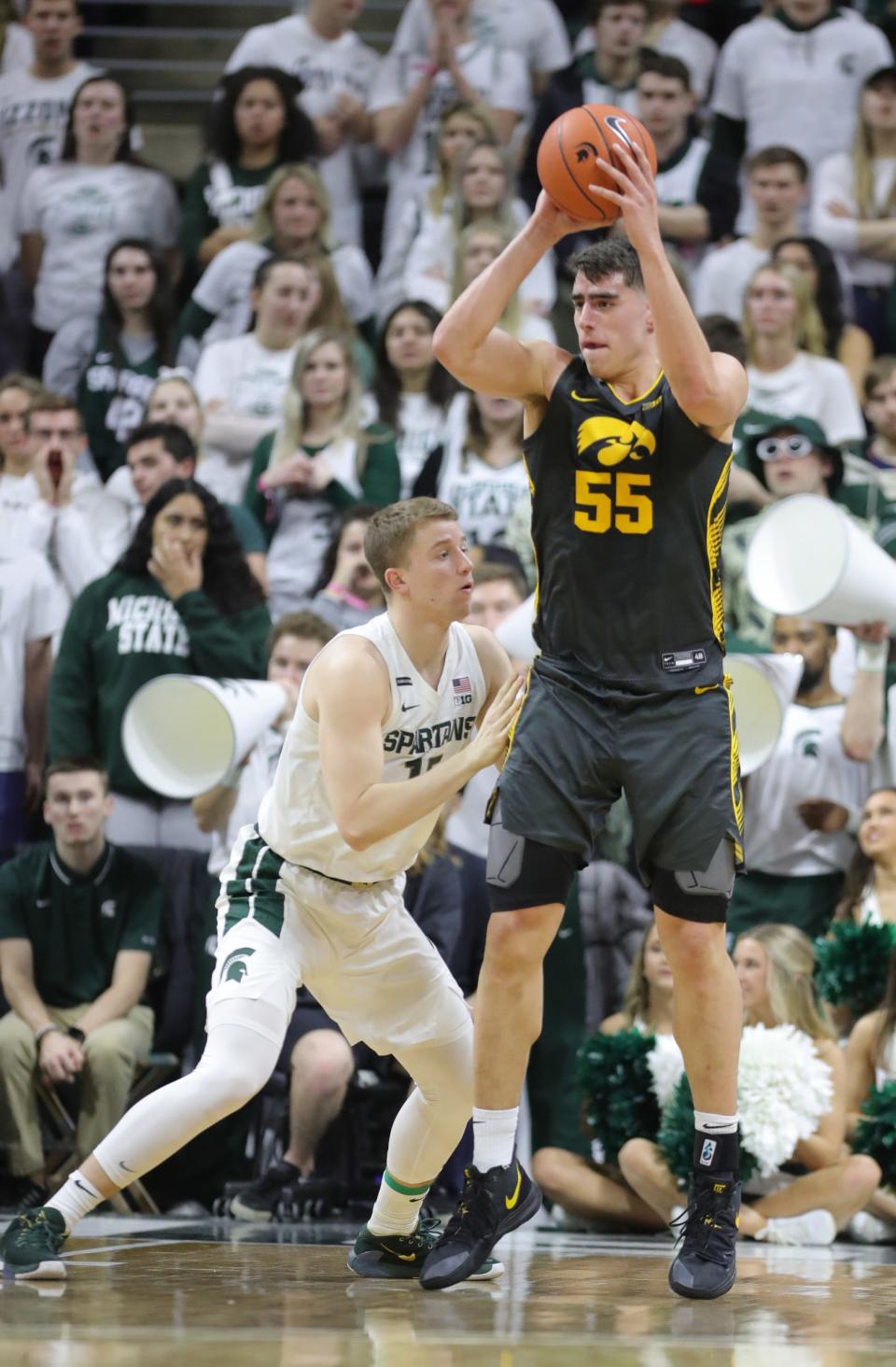 Michigan State Spartans forward Thomas Kithier (15) defends against Iowa Hawkeyes center Luka Garza (55) during first half action Tuesday, February 25, 2020 at the Breslin Center in East Lansing, Mich.