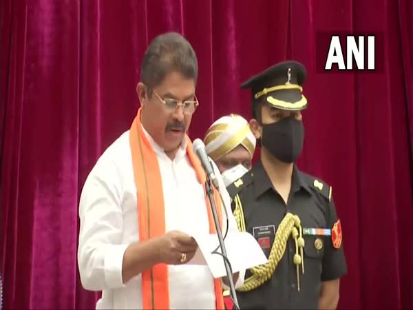 R Ashok taking oath as a minister in the new Karnataka Cabinet at Raj Bhavan in Bengaluru on Weednesday. [Photo/ANI]