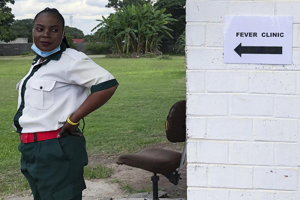 In this Feb. 6, 2020, photo, a security guard stands outside of the Sino-Zambia Friendship Hospital in Kitwe, Zambia. The coronavirus that has spread through much of China has yet to be diagnosed in Africa, but global health authorities are increasingly worried about the threat as health workers on the ground warn they are not ready to handle an outbreak. (AP Photo/Emmanuel Mwiche)